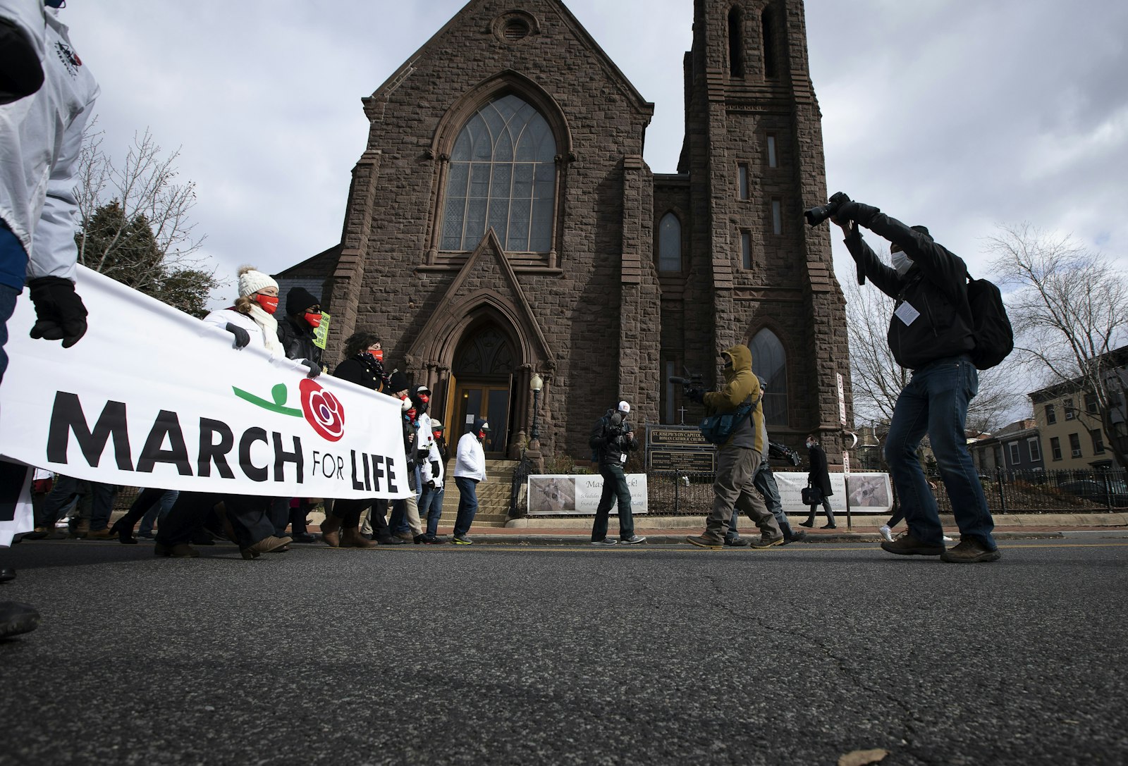 March for Life participants walk past St. Joseph's on Capitol Hill Church on their way to the U.S. Supreme Court building in Washington Jan. 29, 2021, amid the coronavirus pandemic. (CNS photo/Tyler Orsburn)