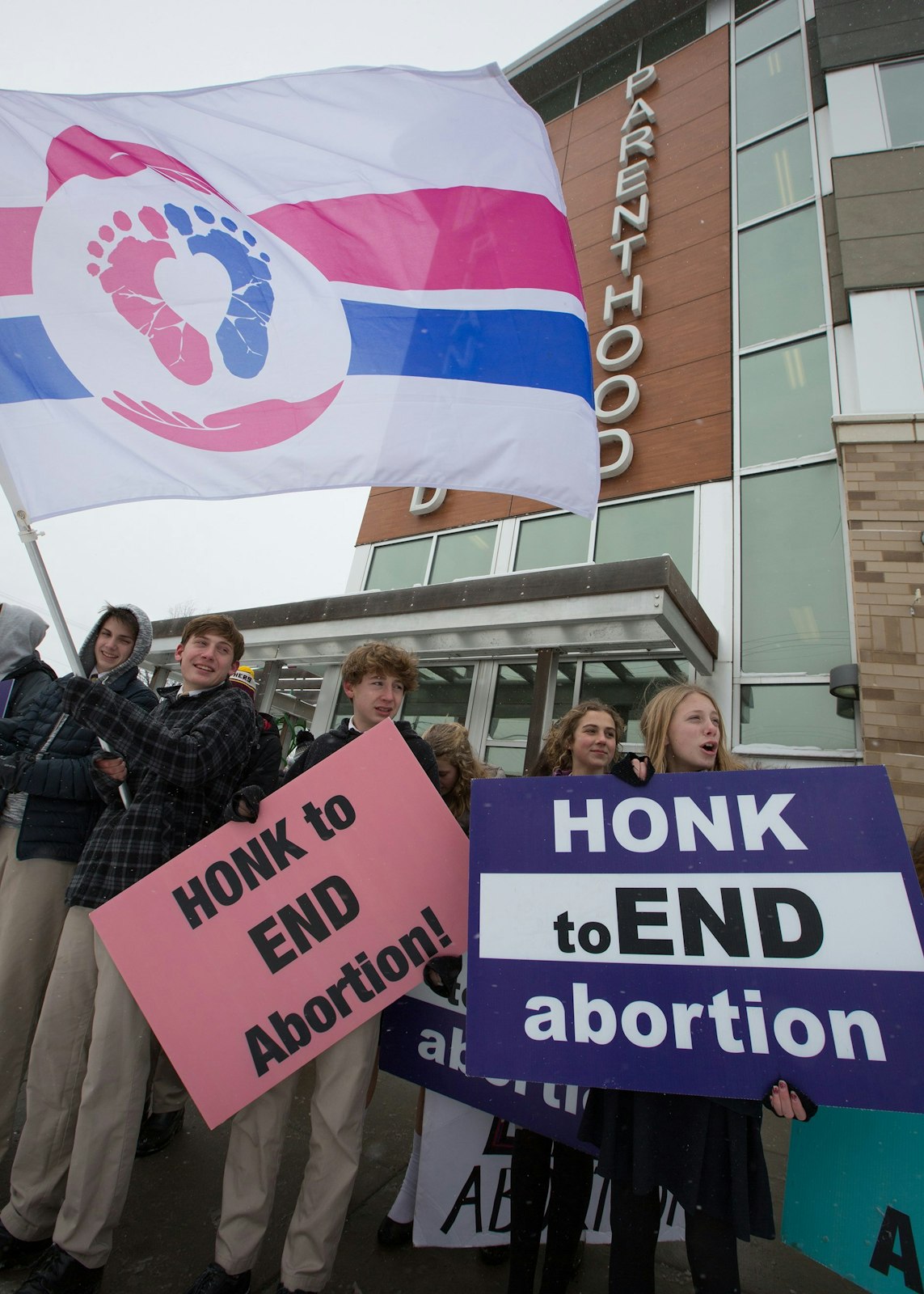 Students from Chesterton Academy in Hopkins, Minn., pray the rosary at Planned Parenthood in St. Paul Jan. 5, 2022. A group of 40 students goes every week to stand up for life at the abortion facility, calling themselves "Crusaders for Life." (CNS photo/Dave Hrbacek, The Catholic Spirit)