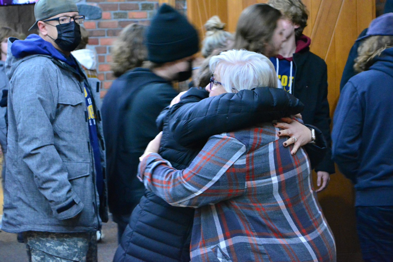People hug one another in the vestibule of St. Joseph Parish in Lake Orion during a Mass on Nov. 30 in the aftermath of a school shooting at nearby Oxford High School. With nearly 1,800 students enrolled, the Oakland County school is one of the largest public high schools in the state.