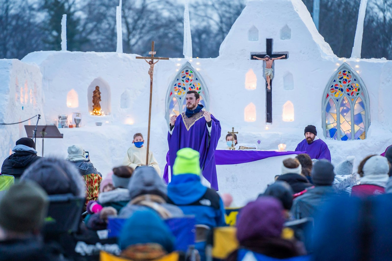 Fr. David Pellican, associate pastor of Divine Child Parish in Dearborn, celebrates Mass on Feb. 21 in a makeshift snow chapel constructed by students and parishioners after a historic snowfall. Fr. Pellican said the chapel took a week to construct, with students doing the heavy lifting and parishioners donating items such as statuary and candles for a special outdoor liturgy. (Valaurian Waller | Detroit Catholic)